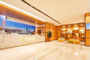 a large lobby with a bar in a building at Chonpines Hotel Guangzhou Sunac Cultural and Tourism City Shiling in Huadu