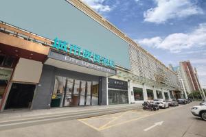 a shopping center with cars parked in a parking lot at City Comfort Inn Wuhan East Lake Scenic Area Happy Valley in Wuhan