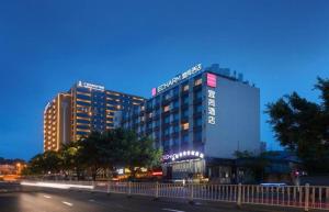 a building with a sign on the side of it at Echarm Hotel Nanning Qingxiu Mountain in Nanning