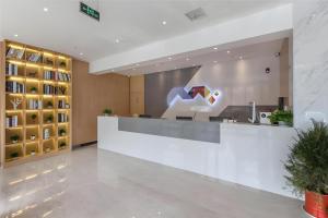 a lobby with a reception desk in a building at Borrman Hotel Wuhan Yangluo Metro Station Shenshuigang in Wuhan