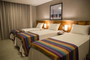 Postel nebo postele na pokoji v ubytování Amenit Hotel