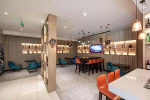 a restaurant with a dining room with tables and chairs at Echarm Hotel 1st Affiliated Hospital of Suzhou University Pingjiang in Suzhou