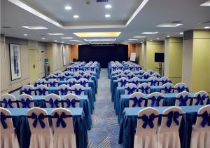 a room full of chairs with blue bows on them at Echarm Hotel Xian Ming City Wall South Gate in Xi'an