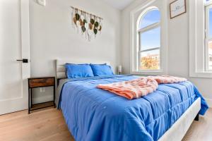 a bedroom with a large bed with blue sheets at 2Bedroom Condo with Private patio in Downtown DC Dupont in Washington