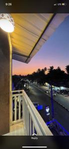 a balcony with a view of a street at night at Hotel sai advika in Guirim