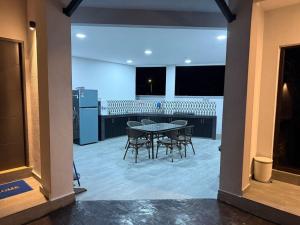 a dining room and kitchen with a table and chairs at Santai TTS BATU RAKIT in Kuala Terengganu