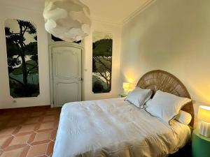 a bedroom with a white bed with two windows at Villa Alexandre III in Dijon