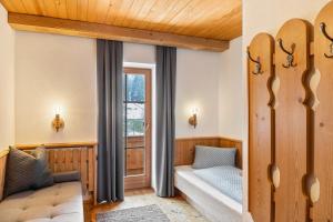 Una sala de estar con un sofá y una ventana. en Schwüwong - Apartment 23, en Kelchsau