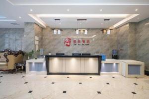 a lobby with a reception desk in a building at PAI Hotels Shijiazhuang Zhengding Gucheng in Zhengding