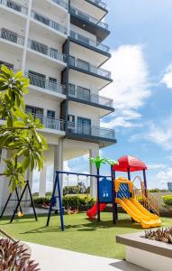 a playground in front of a building at Charming Modern 1 BR Loft in Sampong