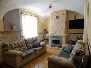 a living room with a couch and a fireplace at Casa Rural Doña Blanca in Santa Cruz de la Sierra