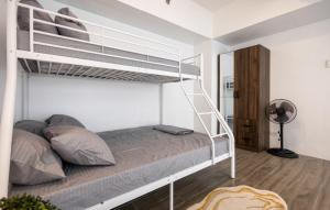 a bedroom with a white bunk bed with a ladder at Charming Modern 1 BR Loft in Sampong +71 photos