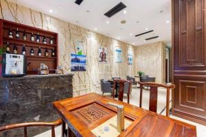 a restaurant with a wooden table and a bar at Yiwu Jane Eyre Love Nest Hotel in Yiwu