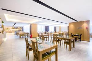 a dining room with wooden tables and chairs at The Hotel V Nanjing Confucius Temple in Nanjing