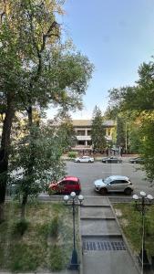 a parking lot with cars parked in front of a building at Апарт-отель ЗОЛОТОЙ КВАДРАТ premium in Almaty +50 photos