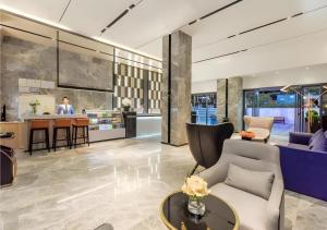 a living room with a couch and a table at Echarm Hotel Guiyang North High-speed Railway Station in Guiyang