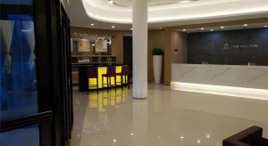 a lobby with tables and chairs in a building at Jinjiang Inn Hengshui Anping in Anping