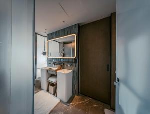a bathroom with a sink and a mirror at Nous Land Beijing in Beijing +22 photos