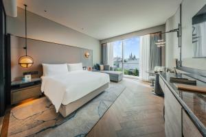 a bedroom with a large bed and a living room at Nous Land Beijing in Beijing