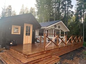 a house with a wooden deck in front of it at Villa Hietikko in Kivijärvi