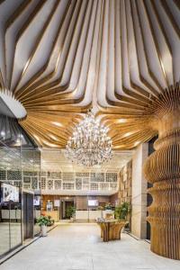 成都市にあるGreenTree Alliance Hotel Chengdu Wenjiang University Townの建物内のシャンデリアのある広いロビー