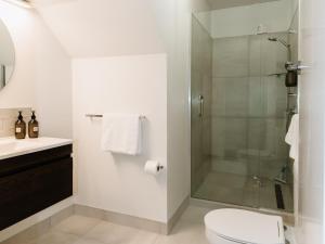 a bathroom with a shower with a toilet and a sink at Tresco Apartments - Quiet Luxury in the Heart of Blenheim in Blenheim +23 photos