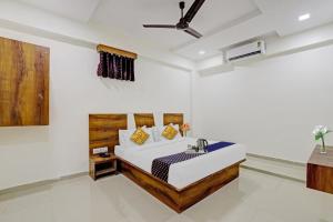 a bedroom with a bed and a sink in it at Hotel O Star in Naroda