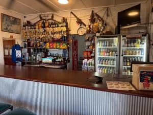a bar in a restaurant with a refrigerator at Royal Hotel Eromanga in Eromanga
