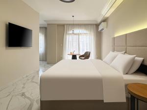 a hotel room with a large white bed and a table at 利恩之家 Maison Lienne in Cairo