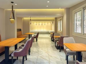 a dining room with wooden tables and chairs at 利恩之家 Maison Lienne in Cairo