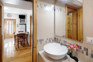 a bathroom with a sink and a table at Ciasa de Lucky in Moena +24 photos