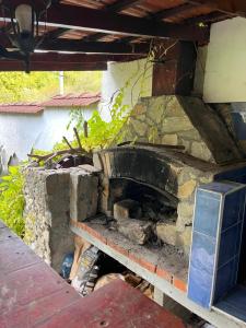 an old stone fireplace in a house with a table at Country House БатЖоро 