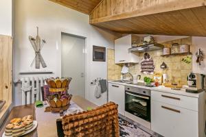 a kitchen with a table and a sink and a stove at Studio Valleverde 33B Ski in Ski Out - Happy Rentals in Sestriere
