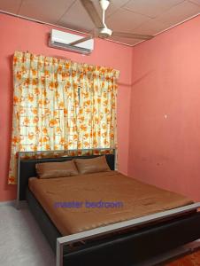 a bedroom with a bed and a window with a curtain at CD Homestay 