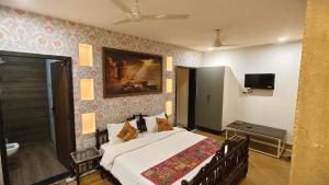 a bedroom with a bed and a television in it at Kiran Apartment By Experience Jaisalmer in Jaisalmer +88 photos