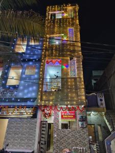 a tall building with christmas lights on it at Shree Hatkeshwar Home Stay Ujjain in Ujjain +14 photos