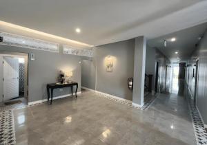 a hallway of a home with a table in it at Thong Prachok Hotel in Sakon Nakhon