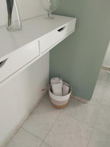 a white counter with a basket under a table at Irenes Apartment in Larnaca +15 photos