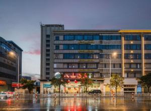 a large building in a city at night at Bashan Hotel in Xiamen