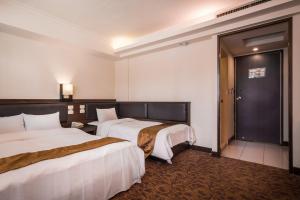 Postel nebo postele na pokoji v ubytování The Enterpriser Hotel