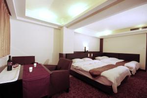 Postel nebo postele na pokoji v ubytování The Enterpriser Hotel