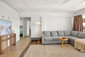 a living room with a couch and a table at Kailoha Unit 8, 27 Canberra Tce, Kings Beach in Caloundra
