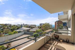 an apartment balcony with a view of the city at Kailoha Unit 8, 27 Canberra Tce, Kings Beach in Caloundra