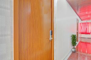 a wooden door in a room with a potted plant at Heavens Inn Near Rasoolpura metro station in Secunderabad