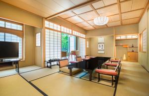 a dining room with a table and chairs and a television at The Prince Park Tower Tokyo - Preferred Hotels & Resorts, LVX Collection in Tokyo