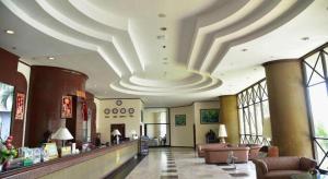 a lobby with a waiting area with a large ceiling at BP Samila Beach Hotel & Resort in Songkhla