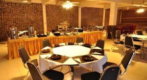 a large room with a table and chairs in it at Piyaporn Hill Paradise Hotel in Mae Sai
