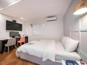 Postel nebo postele na pokoji v ubytování Mac Hotel