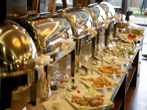 a row of plates of food on a buffet line at Duy Anh Hotel in Hải Dương