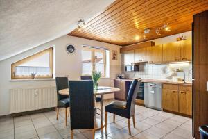 a kitchen with a table and chairs in a room at Sonja in Leutkirch im Allgäu